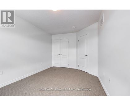 A bedroom with two doors and a carpeted floor.