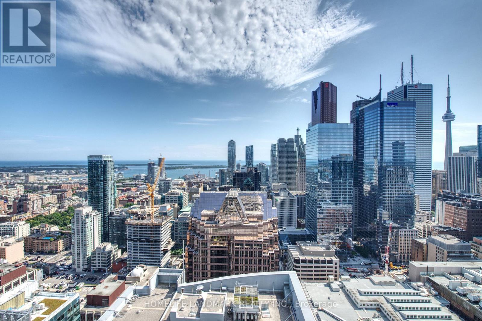 A cityscape with a clear sky and a few clouds.