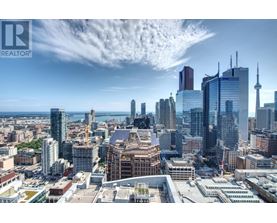 A cityscape with a clear sky and a few clouds.