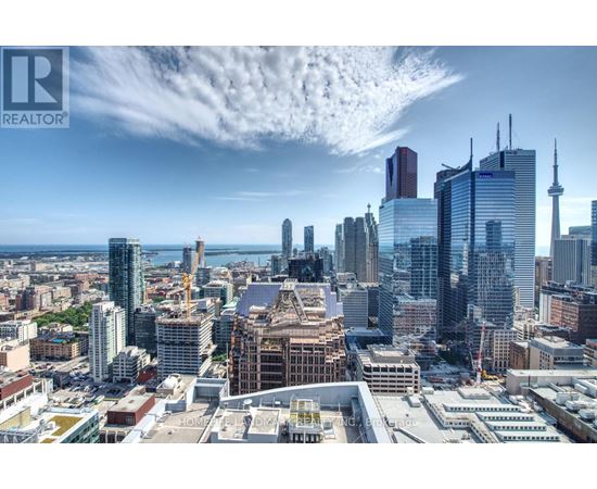 A cityscape with a clear sky and a few clouds.