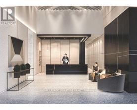 A modern office lobby with a reception desk and a person standing behind it.