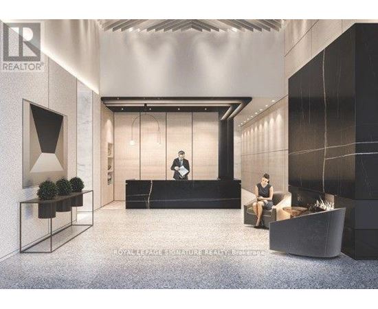 A modern office lobby with a reception desk and a person standing behind it.