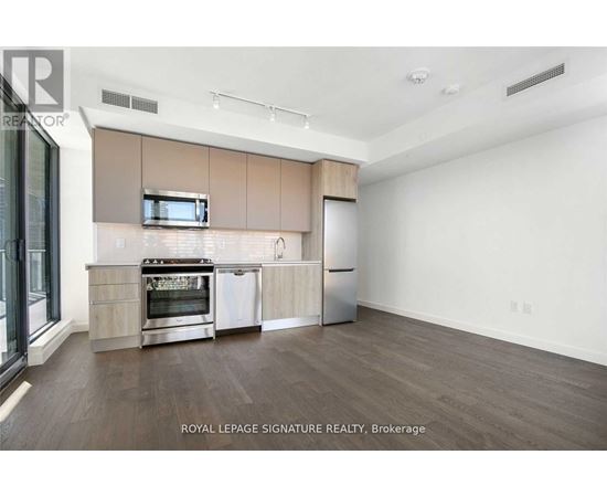 A kitchen with a stove top oven and a microwave above it.