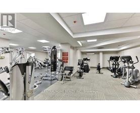 A gym with a variety of equipment including treadmills, weights, and exercise machines.