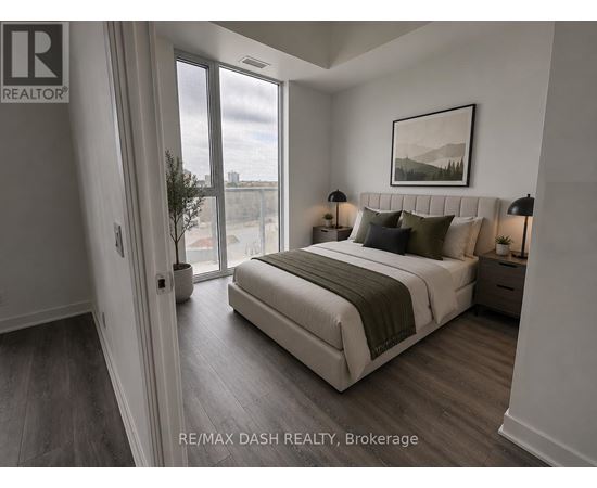 A bedroom with a large bed and a view of the city through the window.