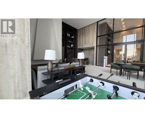 A modern living room with a pool table in the center.