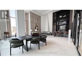 A modern dining room with a black table and chairs.