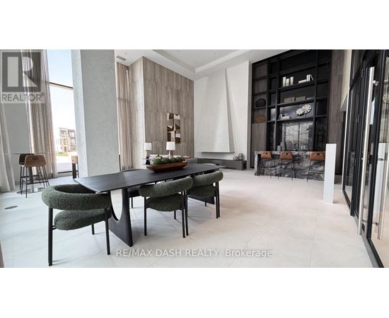 A modern dining room with a black table and chairs.