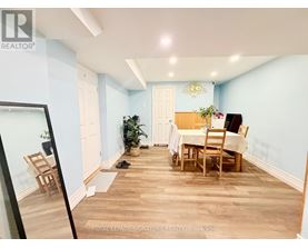 A dining room with a table and chairs.