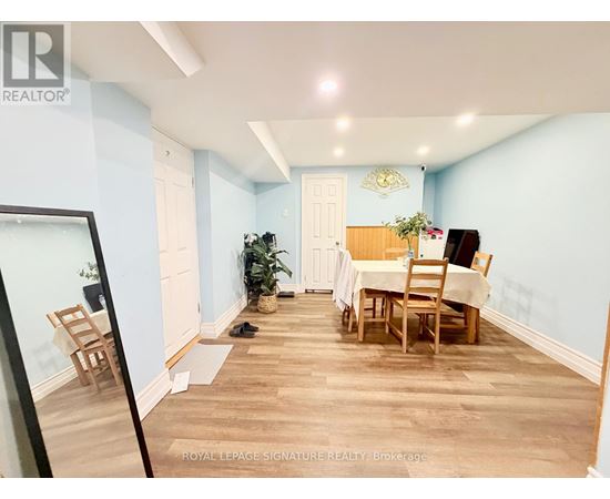 A dining room with a table and chairs.