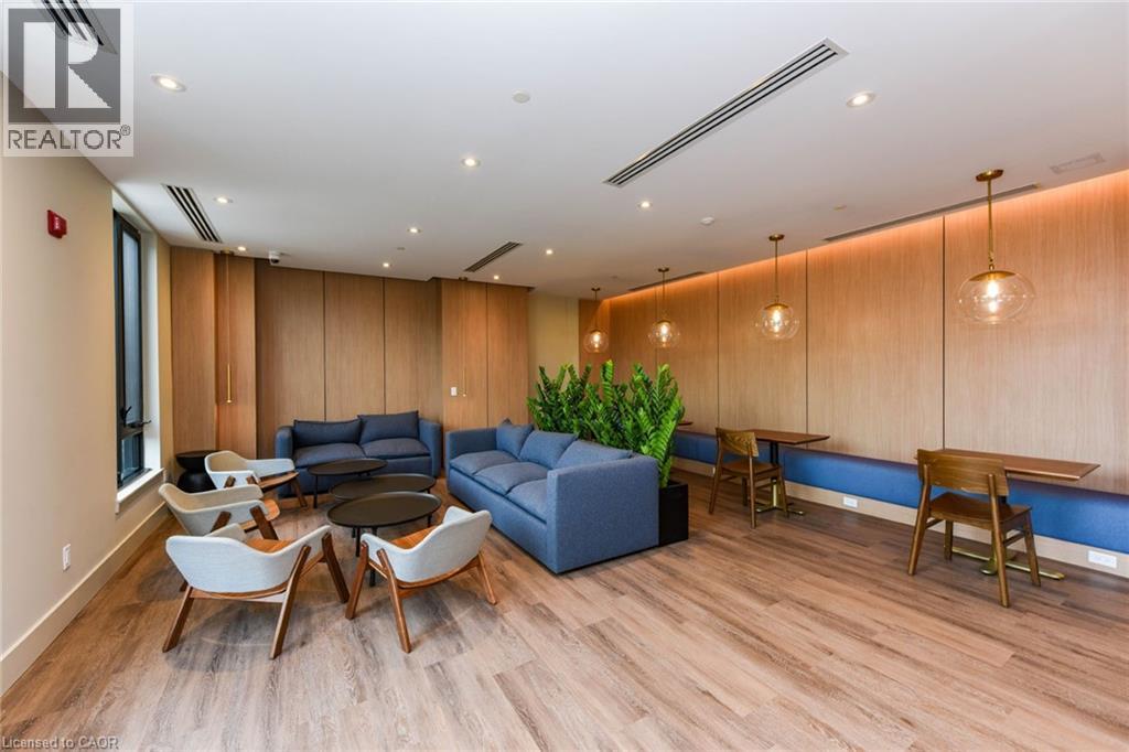 A living room with a blue couch and wooden floors.