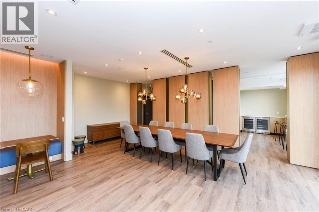 A dining room with a long table and grey chairs.