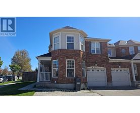 A large house with a brick facade and a white garage door.