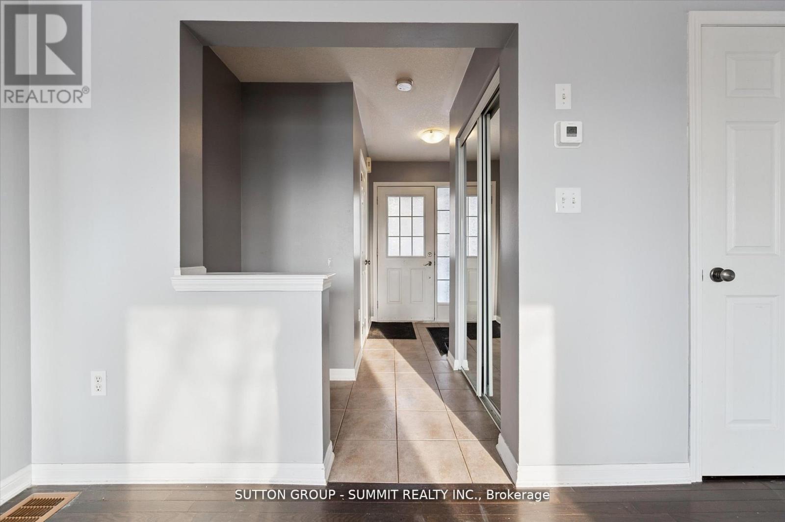 A hallway with a white door and a window.