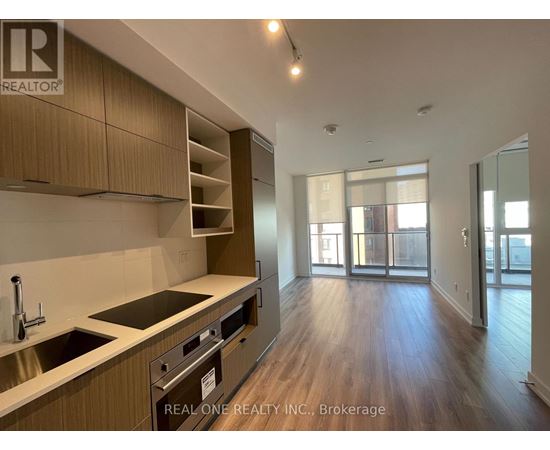 A kitchen with wooden cabinets and a stainless steel sink.