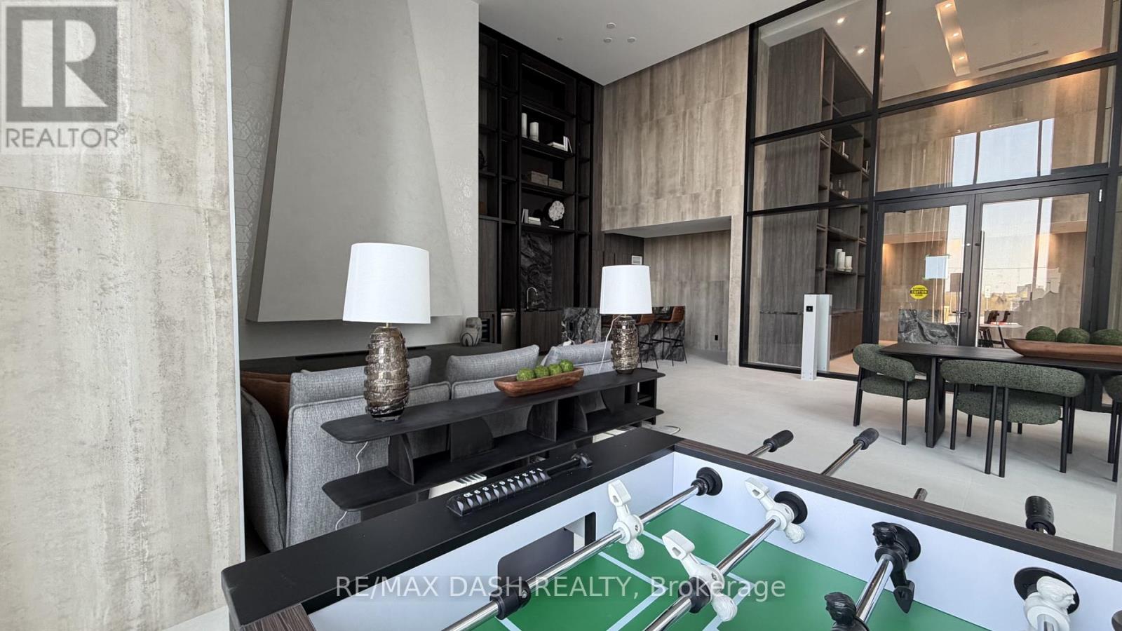 A modern living room with a pool table in the center.