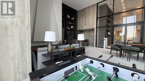A modern living room with a pool table in the center.