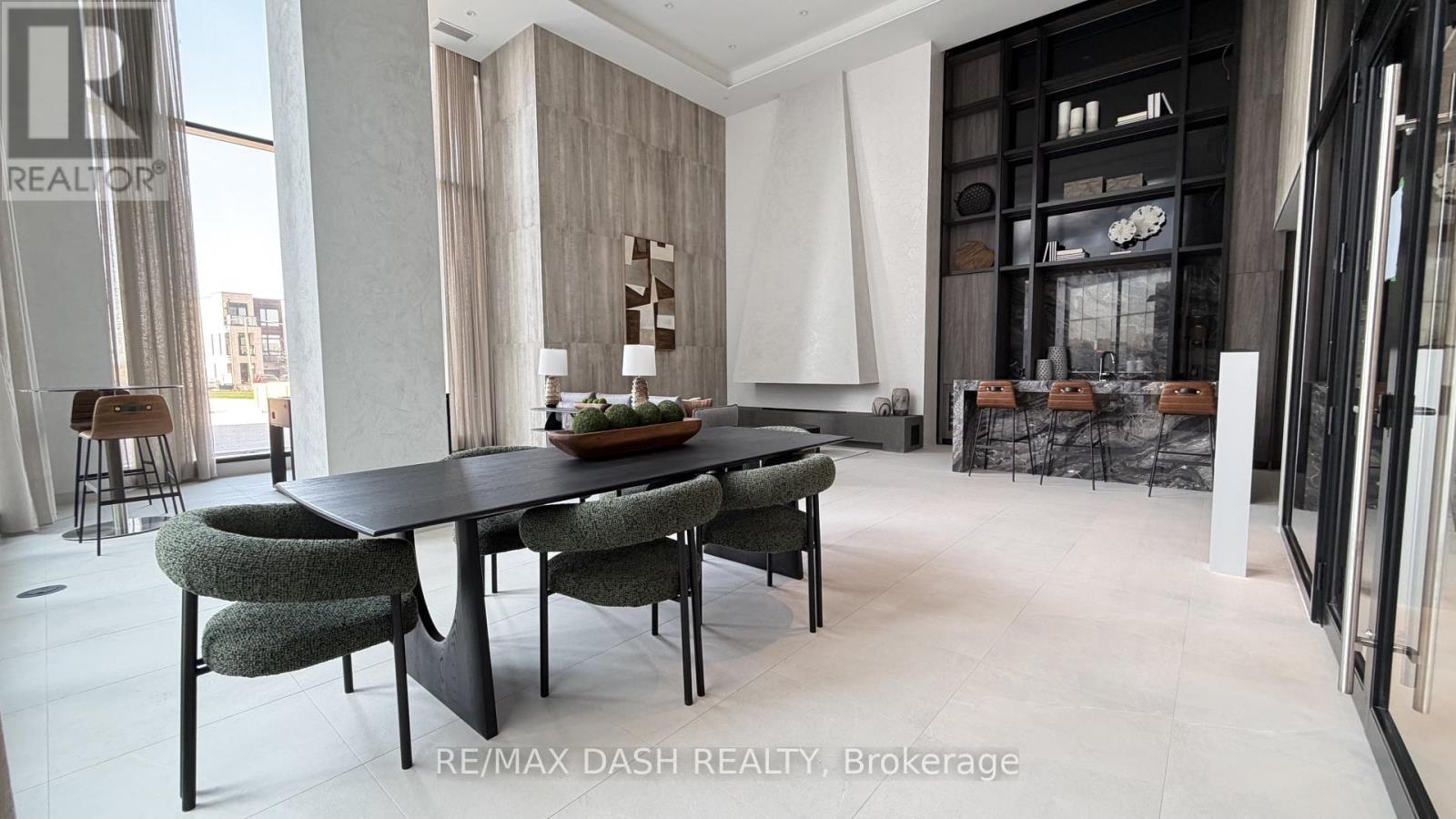 A modern dining room with a black table and chairs.