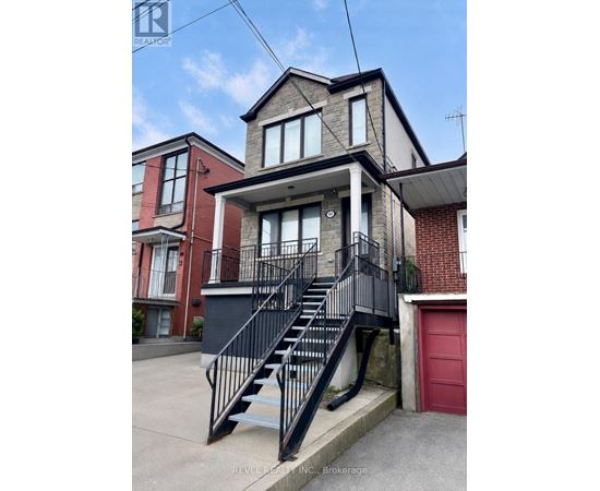 A house with a red door and a black staircase.
