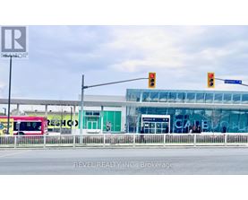 A bus is parked in front of a building with the word "REVEL" on it.