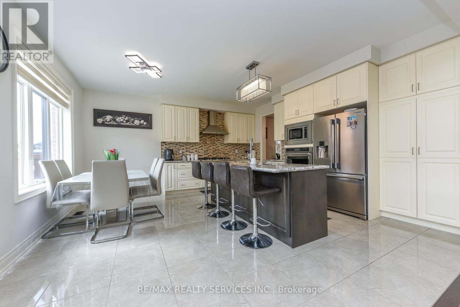 A modern kitchen with a dining table and chairs.