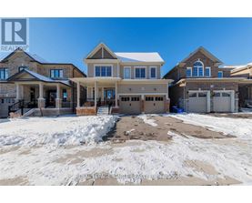 A large, multi-level house with a snow-covered front yard.