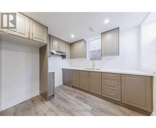 A kitchen with beige cabinets and a white countertop.