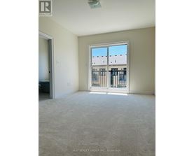 A room with a large window and a view of a building across the street.