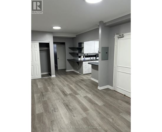 A room with a grey floor and white walls.