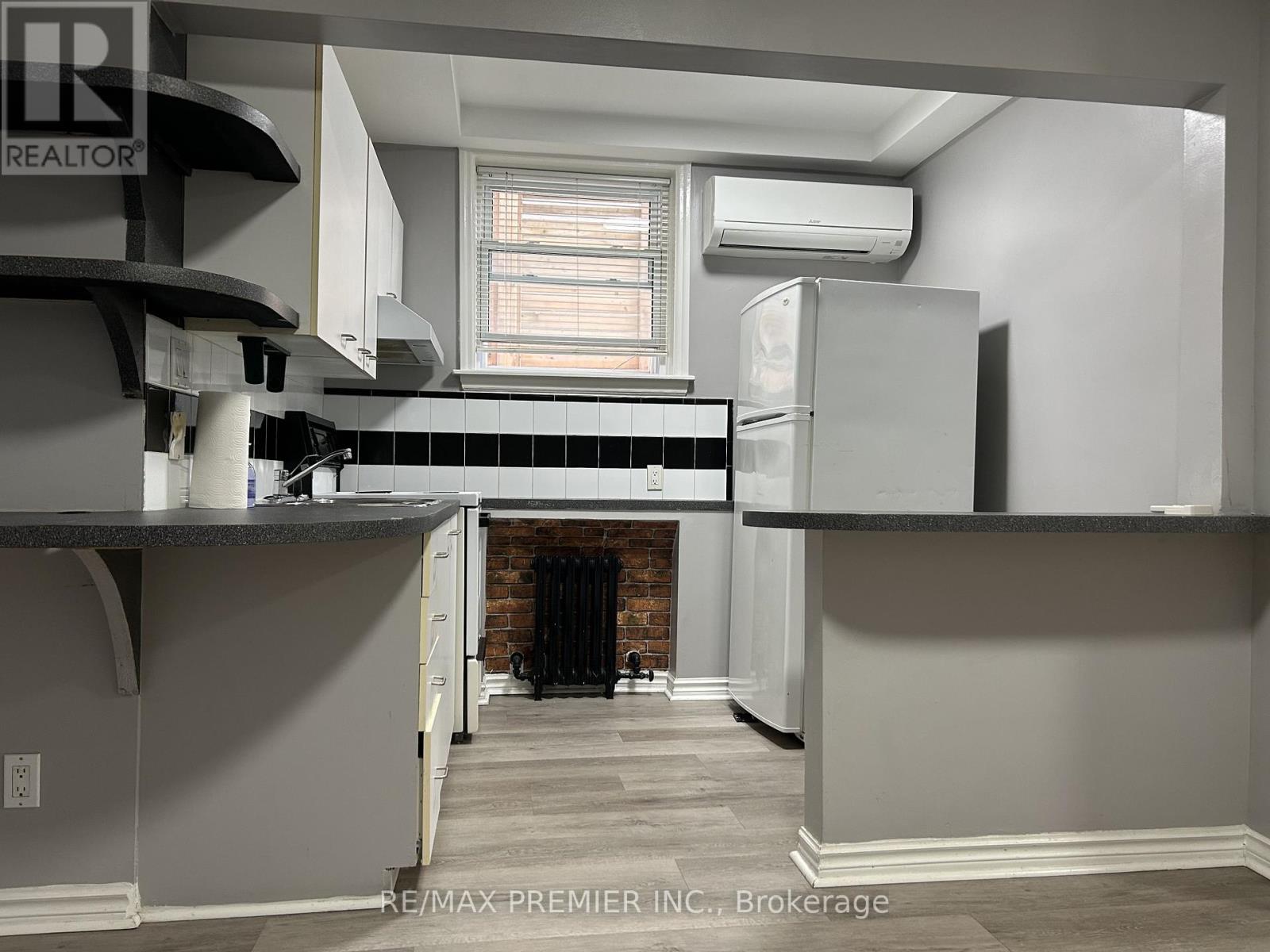 A kitchen with a refrigerator, stove, and oven.