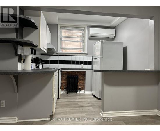 A kitchen with a refrigerator, stove, and oven.