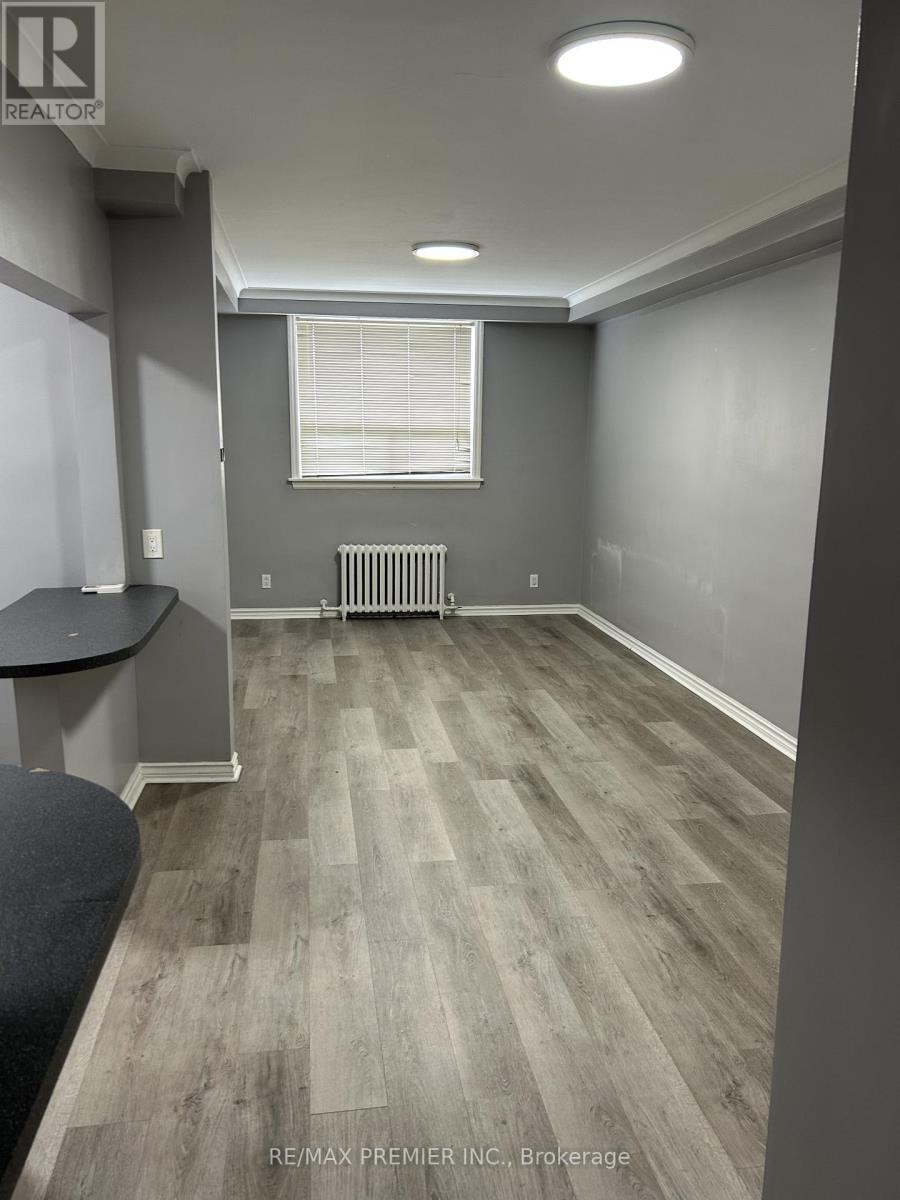 A room with grey walls and a wooden floor.