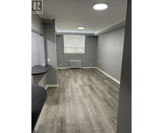 A room with grey walls and a wooden floor.