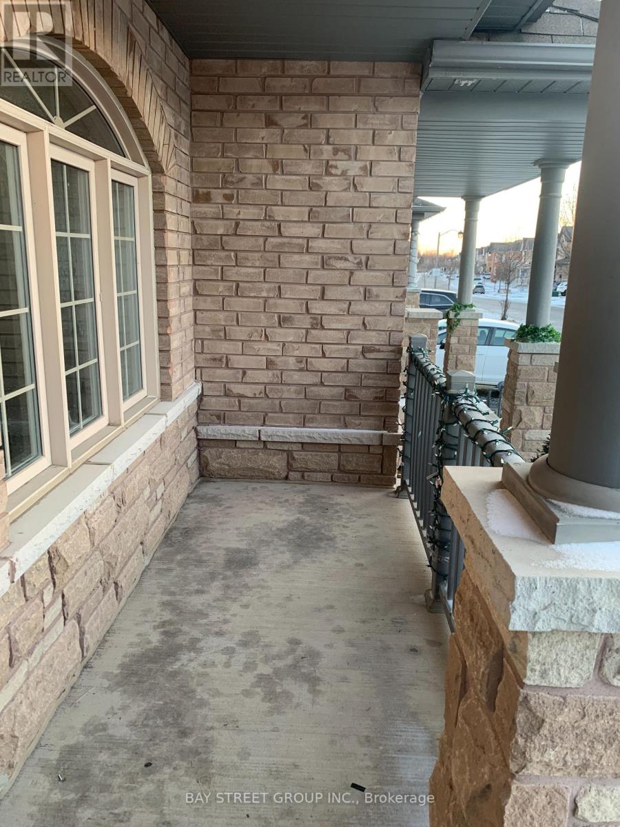A patio area with a brick wall and a window.