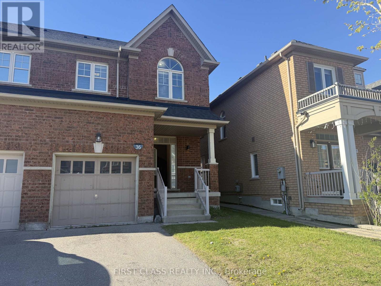 A brick house with a garage door and a window.