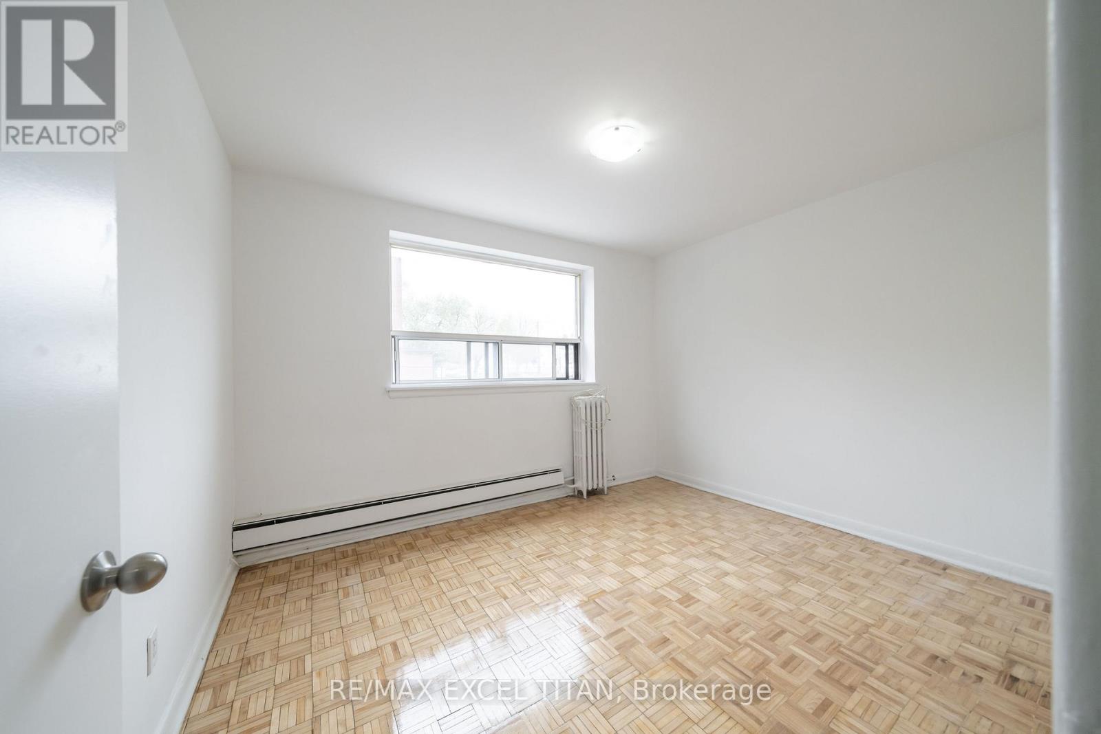 A room with a window and a radiator on the wall.