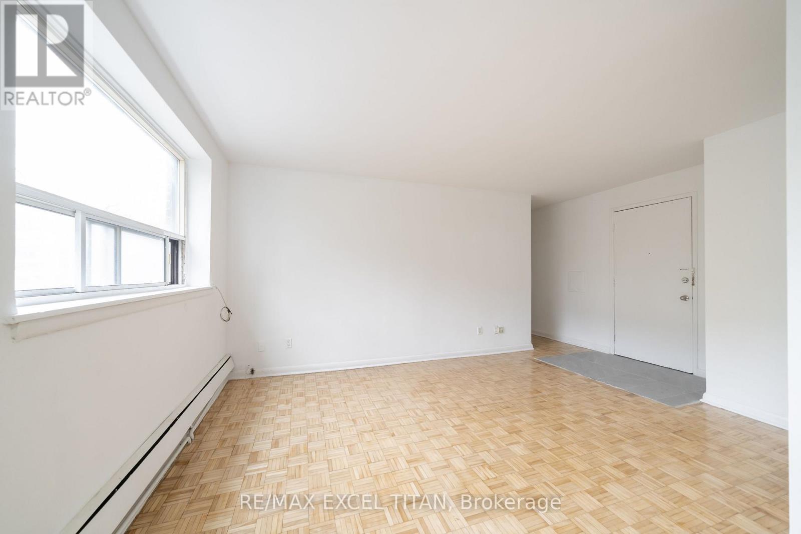 A room with a wooden floor and white walls.