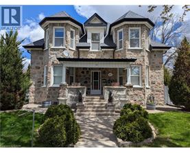 A large house with a stone facade and a large front porch.