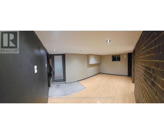 A room with a black wall and a wooden floor.