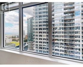 A window overlooks a cityscape with a mix of residential and commercial buildings.