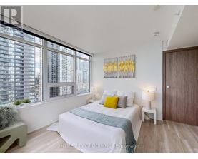 A bedroom with a large bed and a view of a city skyline.