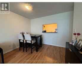A dining room with a table and chairs.