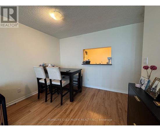 A dining room with a table and chairs.