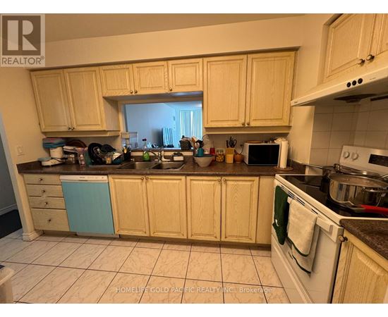 A kitchen with wooden cabinets and a white stove top oven.
