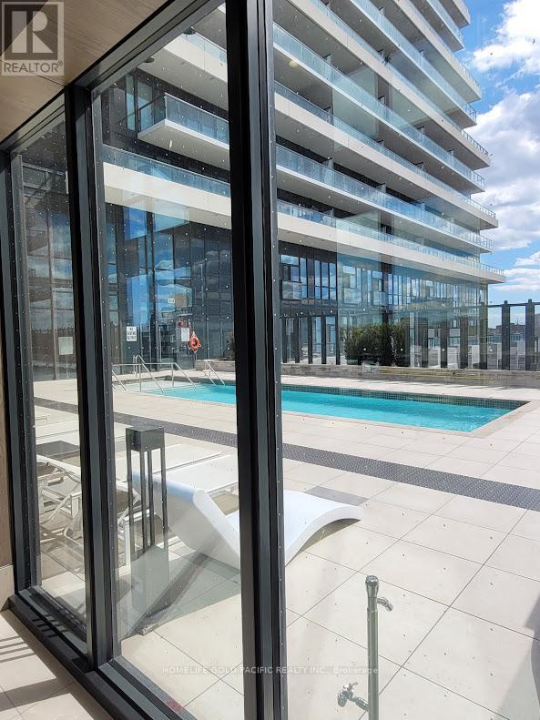 A modern building with a pool in the foreground.