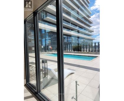 A modern building with a pool in the foreground.