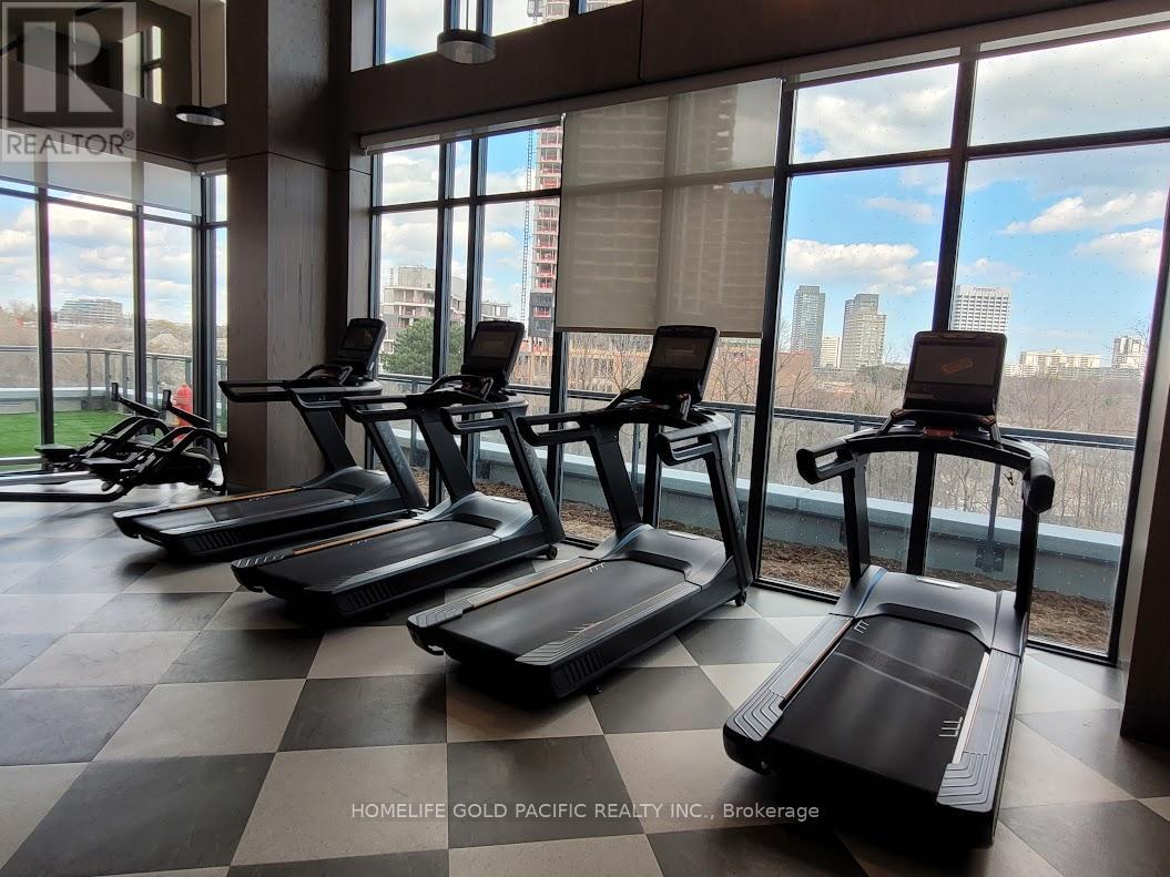 A gym with treadmills and a view of the city.