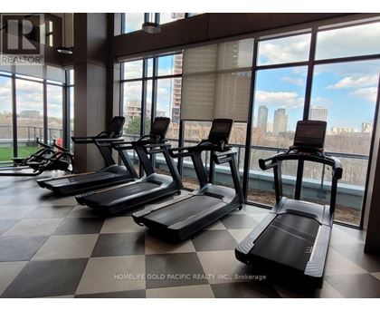 A gym with treadmills and a view of the city.