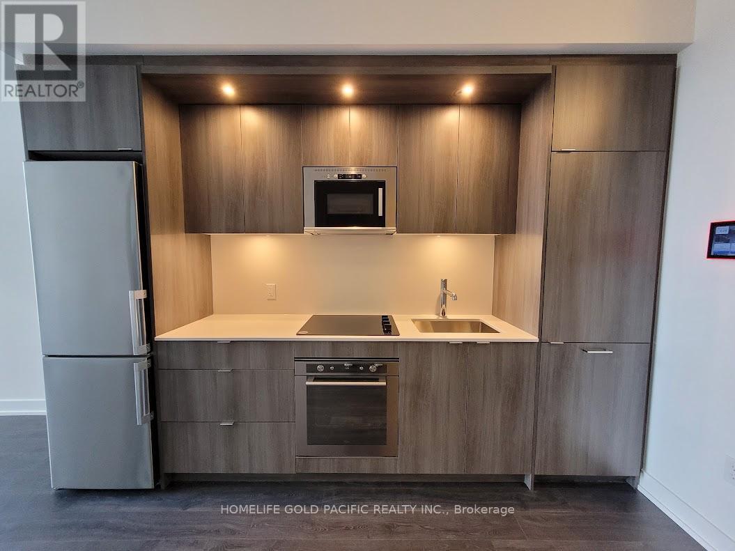 A modern kitchen with wooden cabinets and stainless steel appliances.