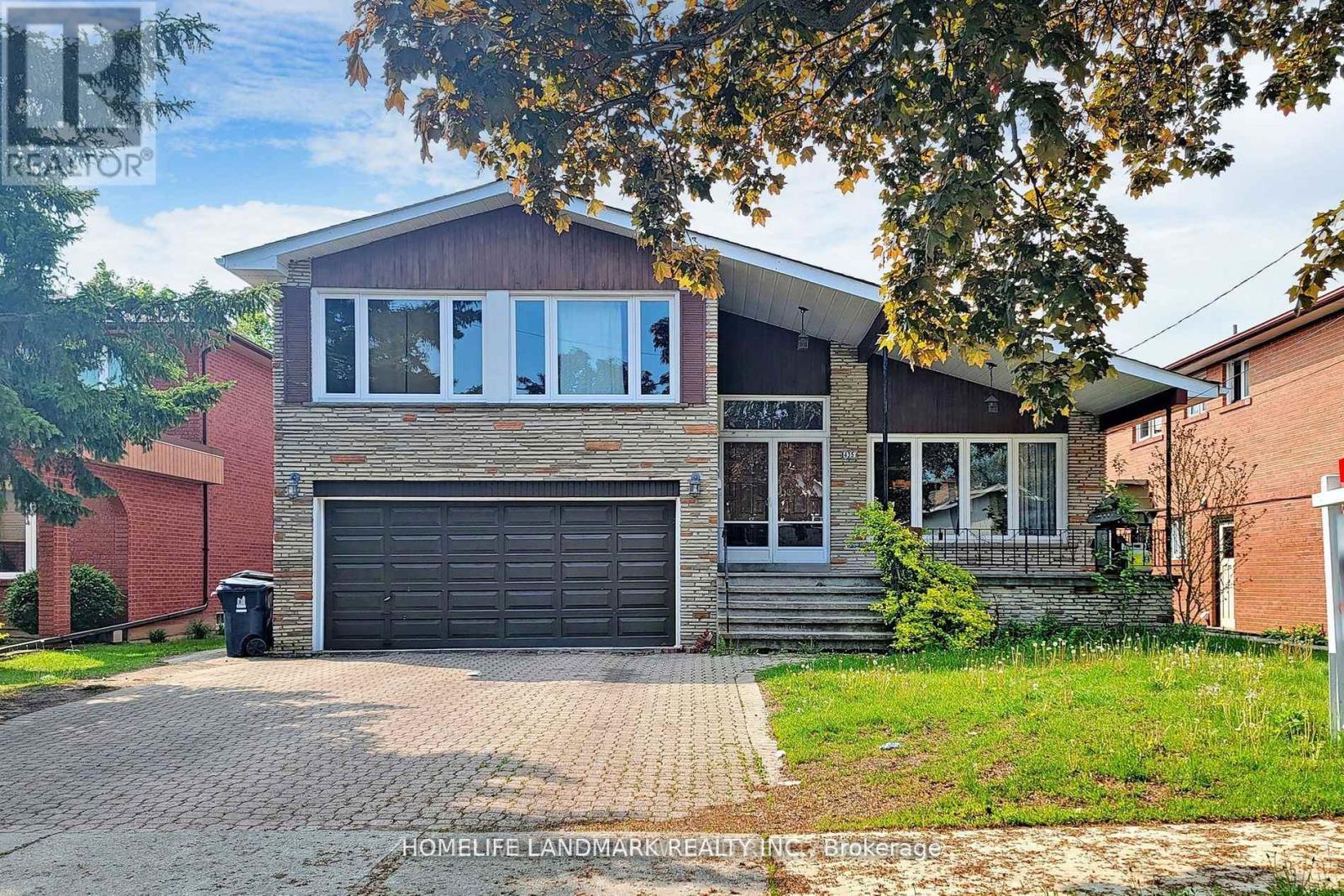 A house with a brick facade and a large garage door.